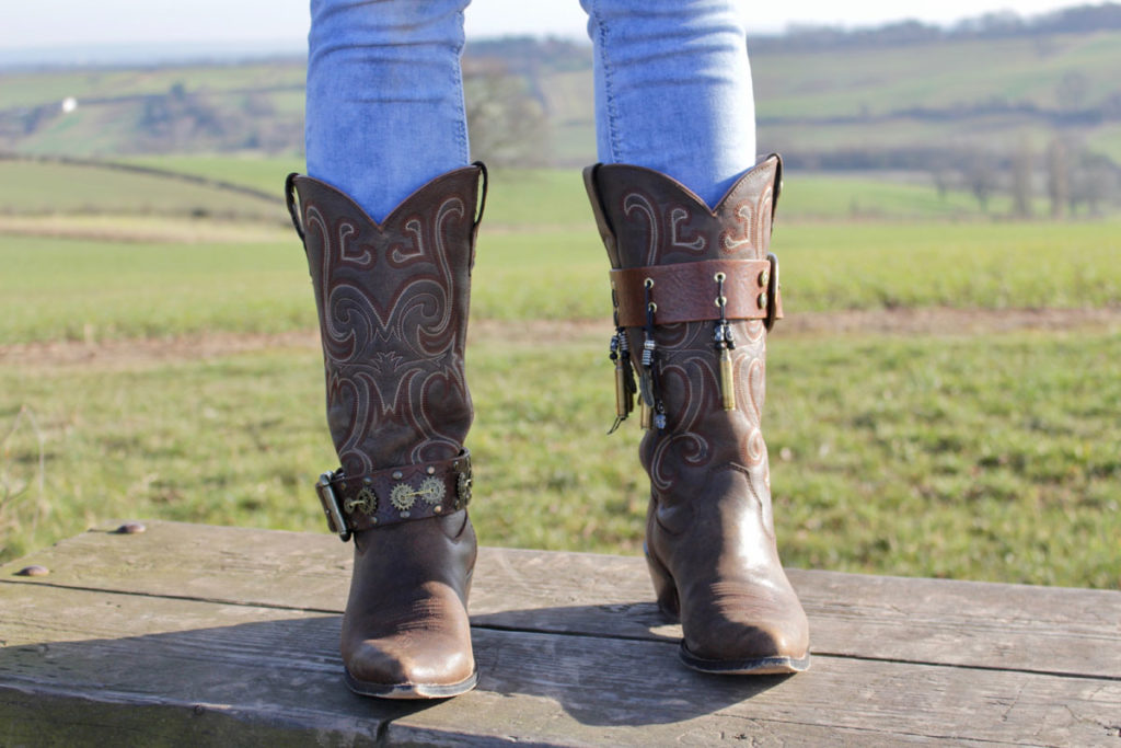 Girl in boots wearing vintage bad JuJu boot straps