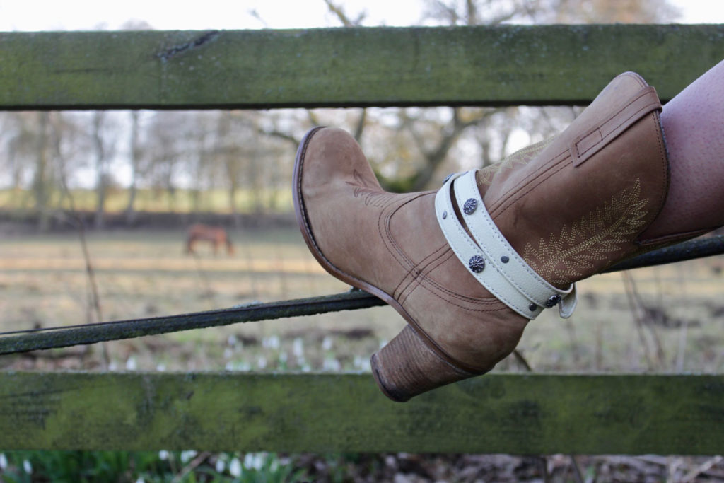 Girl with boot on fence in Boot JuJu