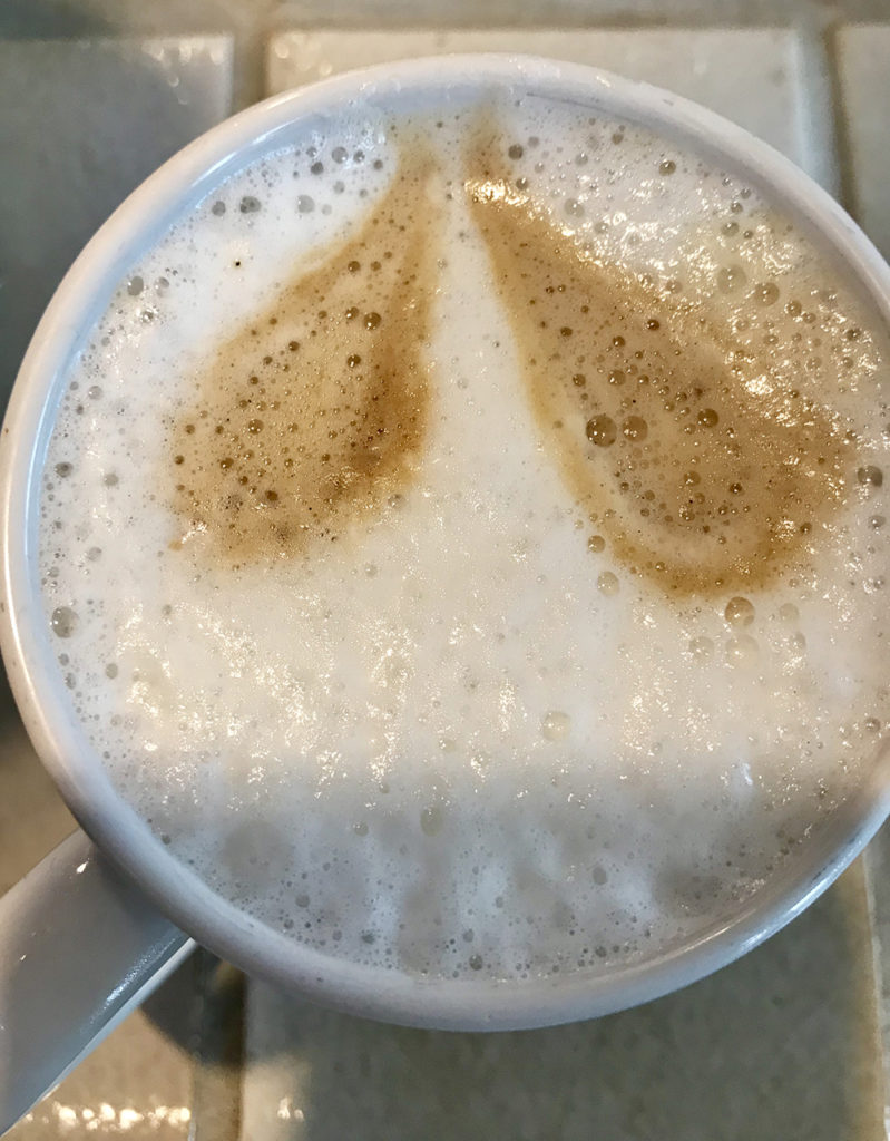 Frothy latte in mug