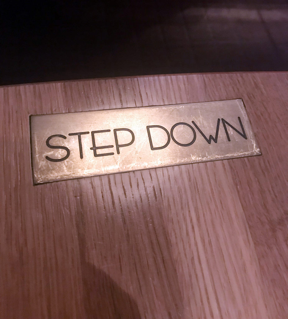 Step Down sign on table