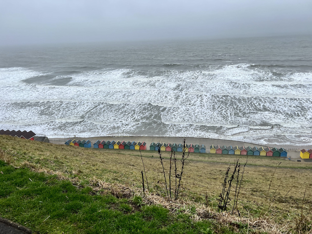 view of the beach and beach huts at Whitby from the top