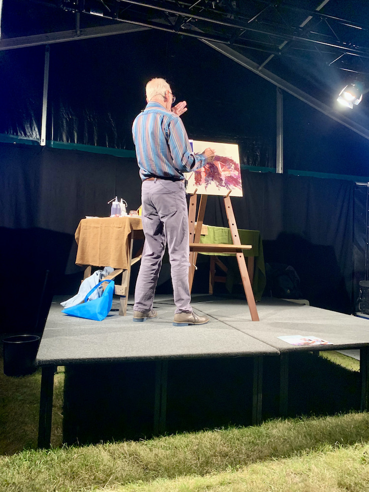 artist showing picture on stage