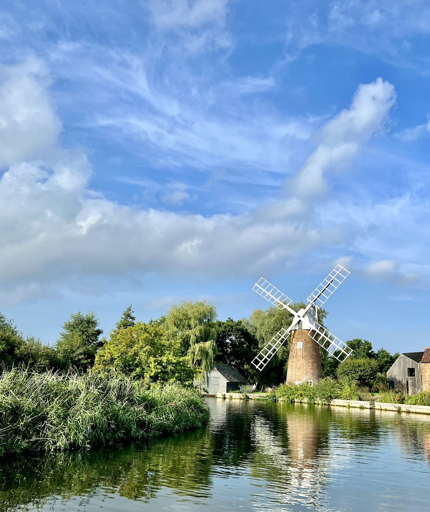 A windmill on the river bank in Norfolk