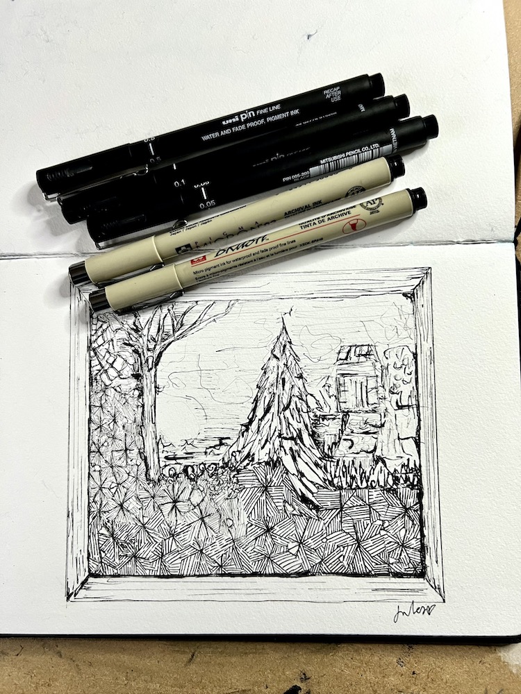 sketchbook and pens and drawing of a frost outside through the window. Ink drawing.