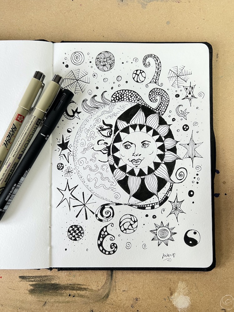 sketchbook and finalisers depicting a celestial drawing in pen and ink