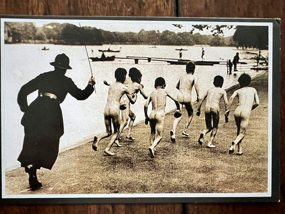 A group of boys running away from a police officer after being caught skinny dipping in the Serpentine, London 1926