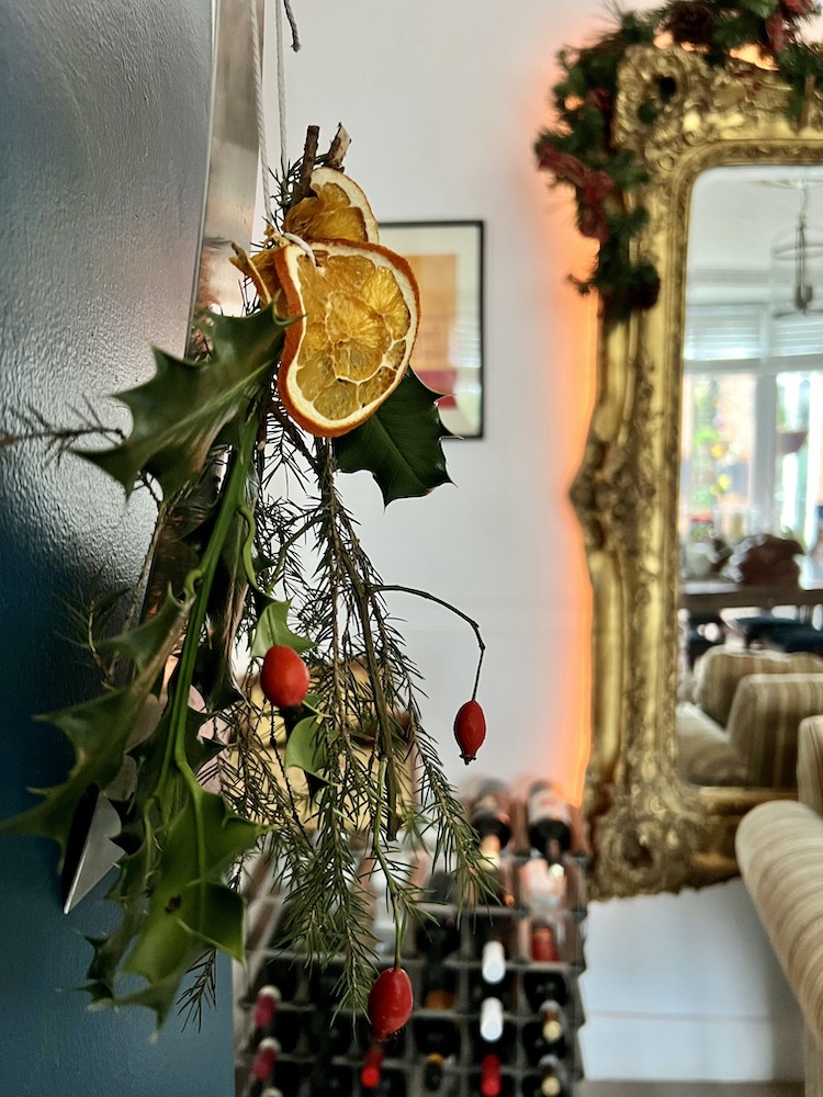 Holly, dried orange and fir arrangement made from foraging